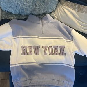 Blue, Purple,& White long sleeve Athletic Pullover with “New York” going across